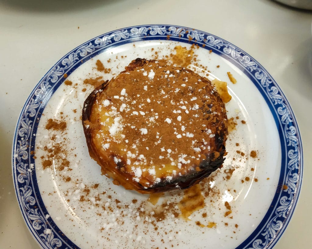 Portuguese custard tarts covered in cinnamon and sugar