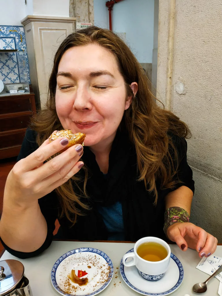 Girl eating Portuguese custard tart