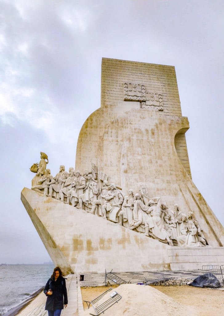 Girl walking by The Monument to the Discoveries in Lisbon, Portugal