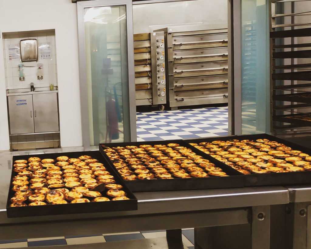 Freshly baked trays of pasteis de nata in Lisbon