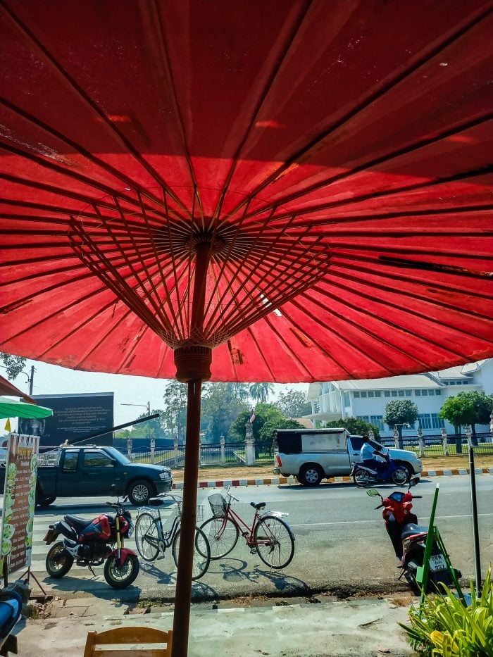 Sitting underneath an umbrella drinking smoothies