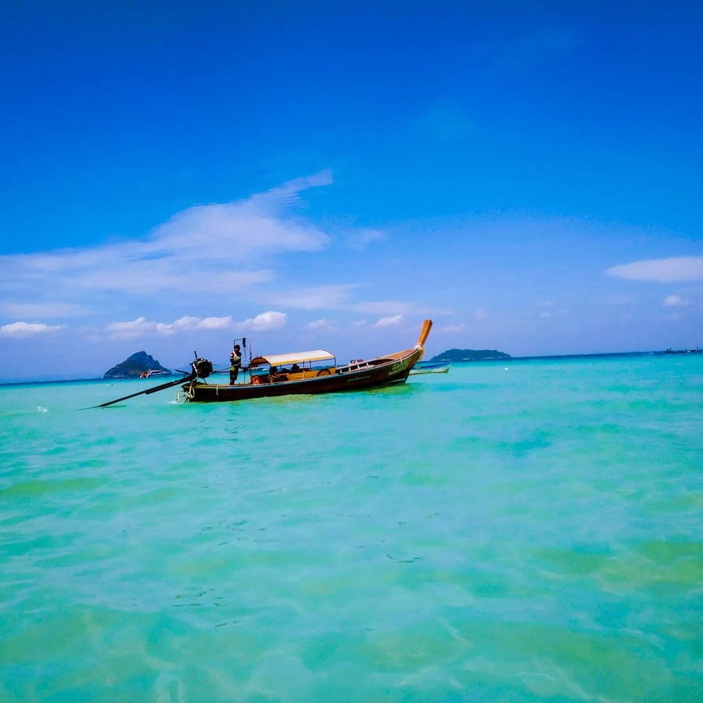 Thai long-tail boat anchored in the water.