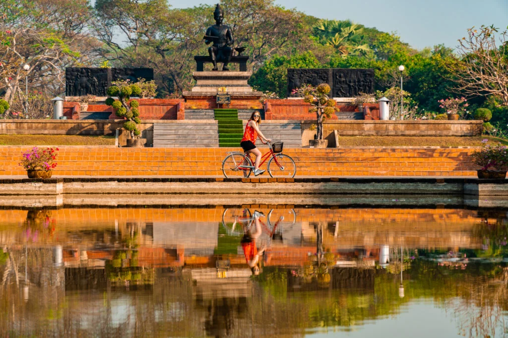 Water reflections of a person on a bike in Sukhothai Thailand