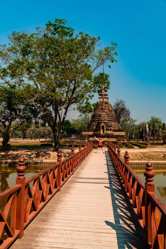 bridge over water to temple in Sukhothai Thailand
