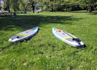 Two SUPs at Lake Sammamish Park on the grass