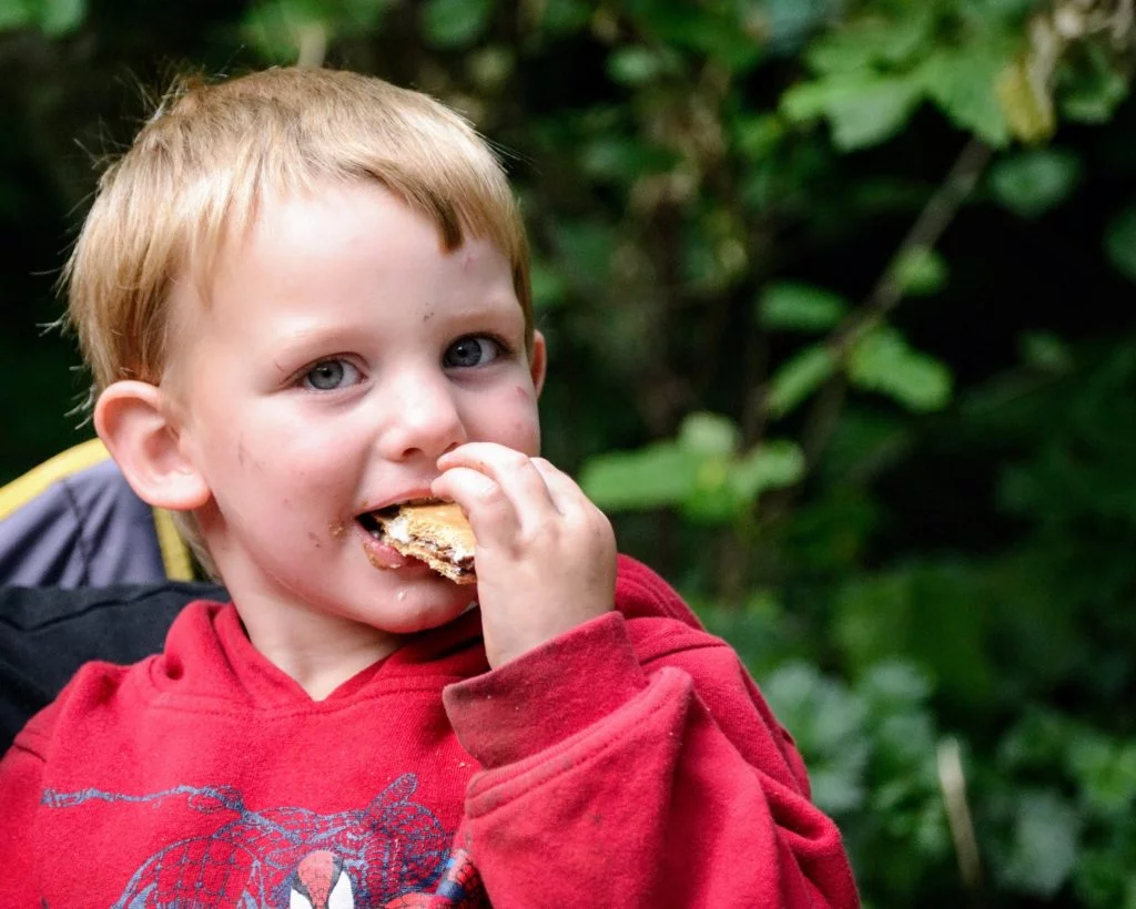 boy eating s'mores for the first time