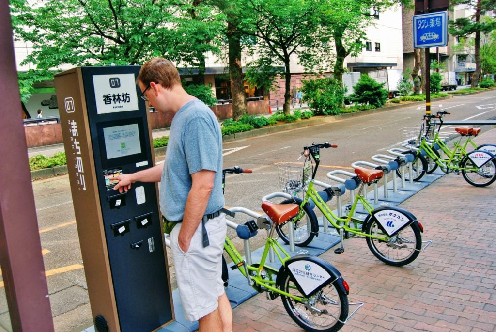 man at bike station in Kanazawa, Japan.