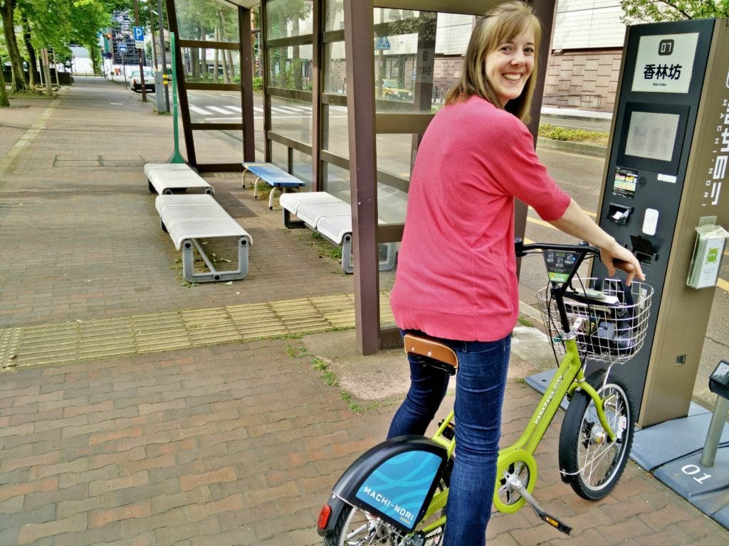 girl on public bike in Kanazawa Japan