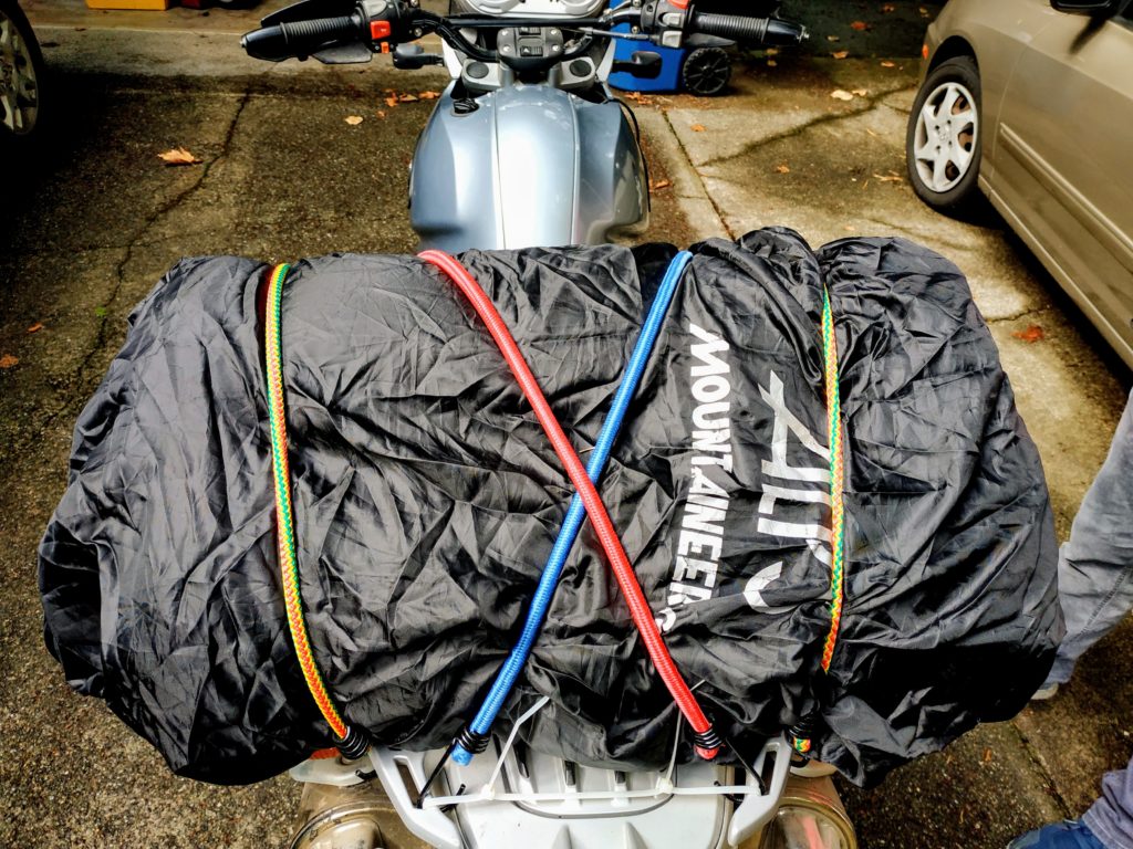 Dual Sport Motorcycle tent packed on the back with bungees and rain cover