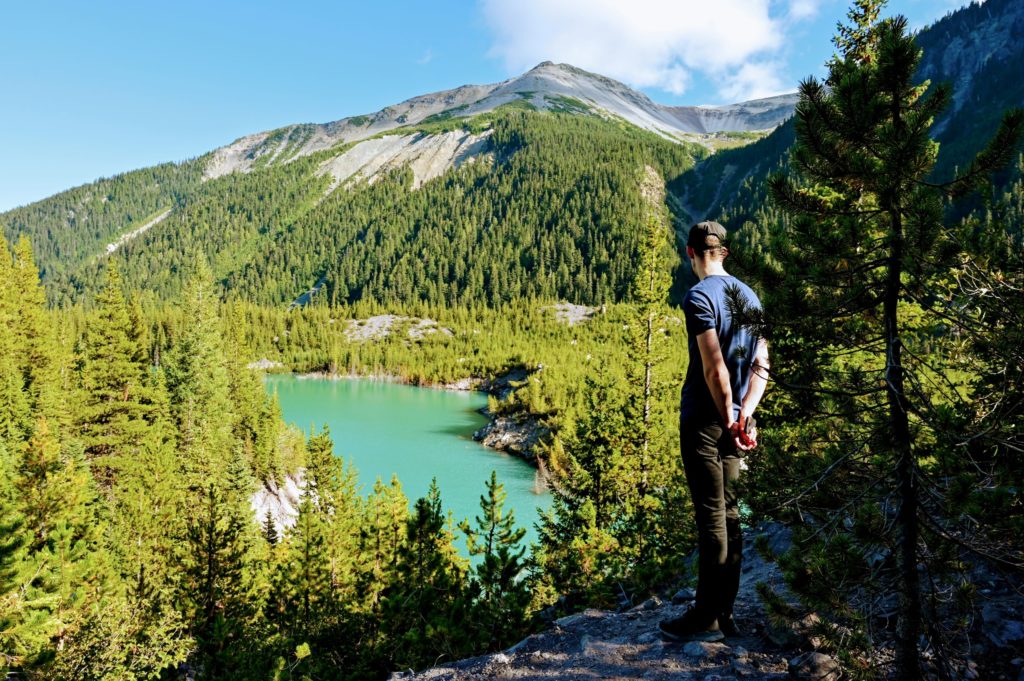 Hiker looking down at the glacial ponds formed from Emmons Moraine Glacier