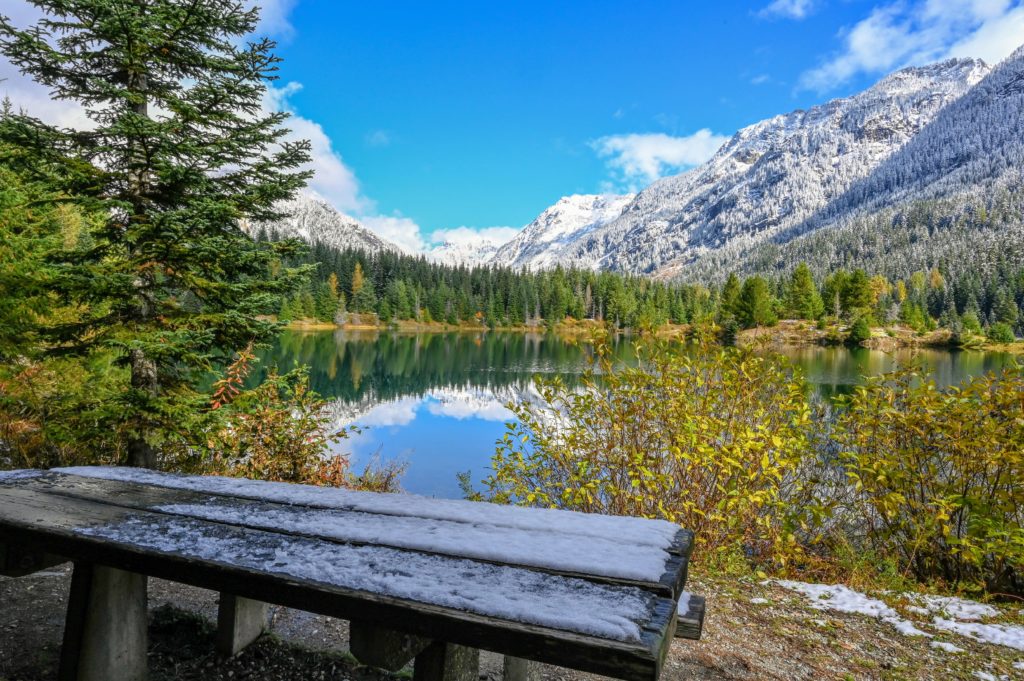 snowy bench by the water at Gold Creek Pond