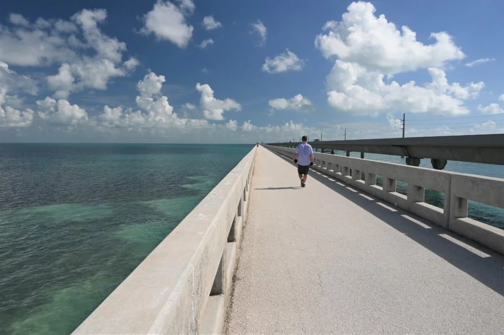 man walking up old seven-mile bridge in Florida Keys
