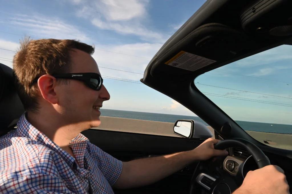 man driving in convertible