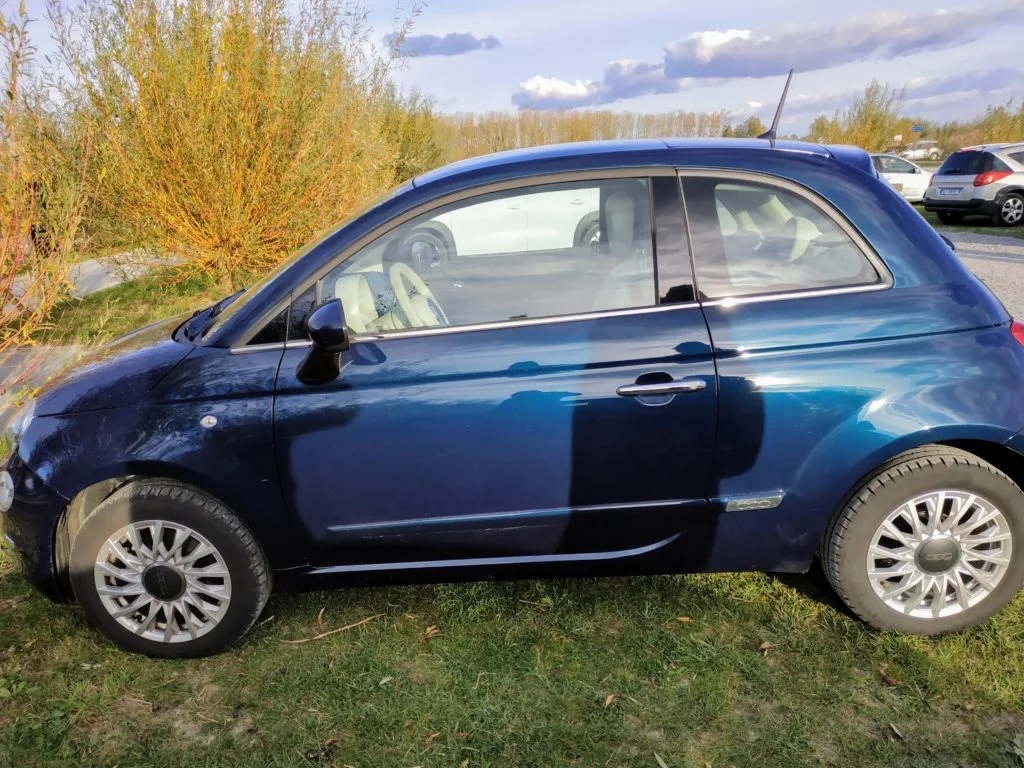 Blue Fiat 500 rented in Normandy.