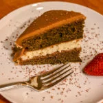 coffee cake with shavings and a strawberry