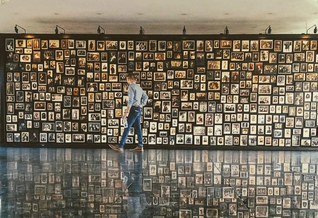 wall of photographs from those murdered at Auschwitz