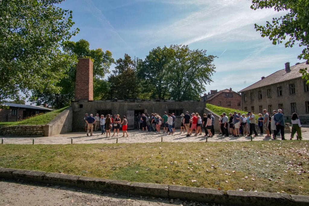 tourists at crematorium in Auschwitz