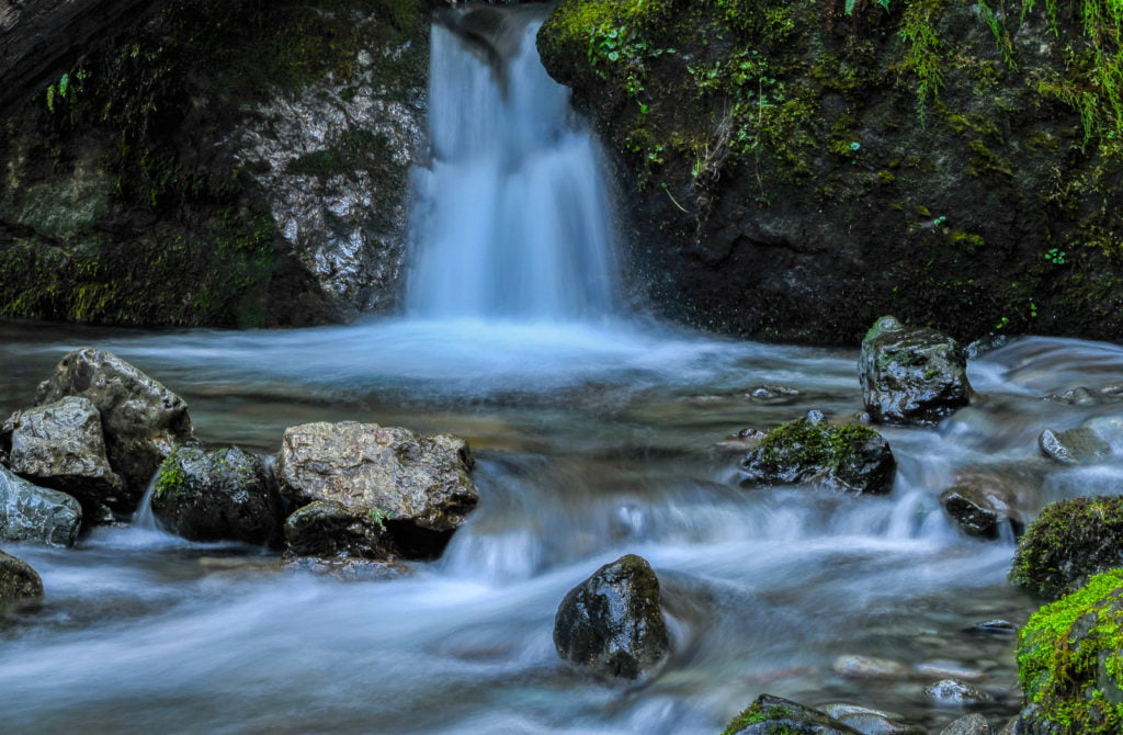 small waterfall with rocks and a stream