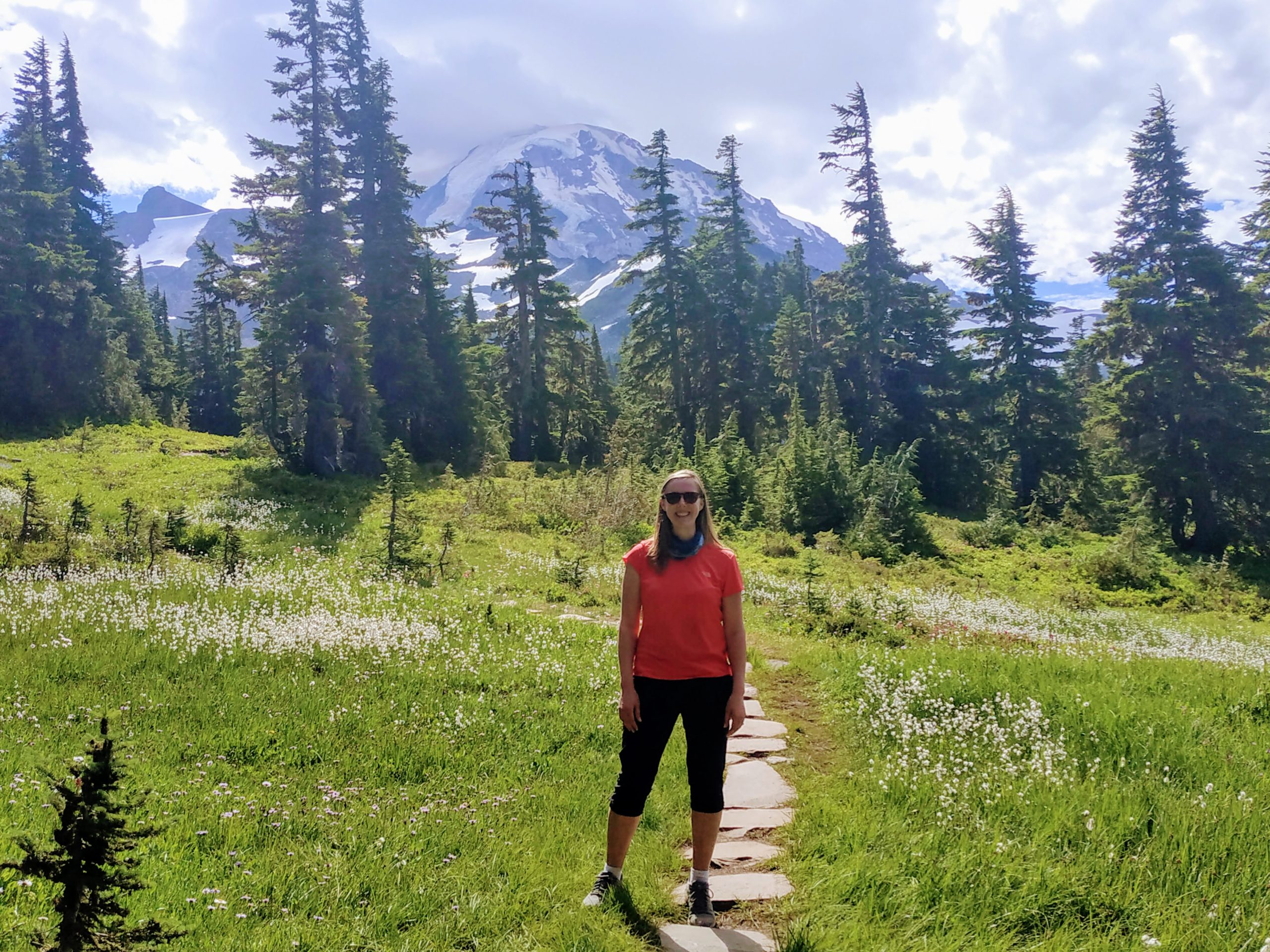 A hiker with Mt Rainier in the background.