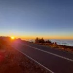 driving with the sunset above the clouds