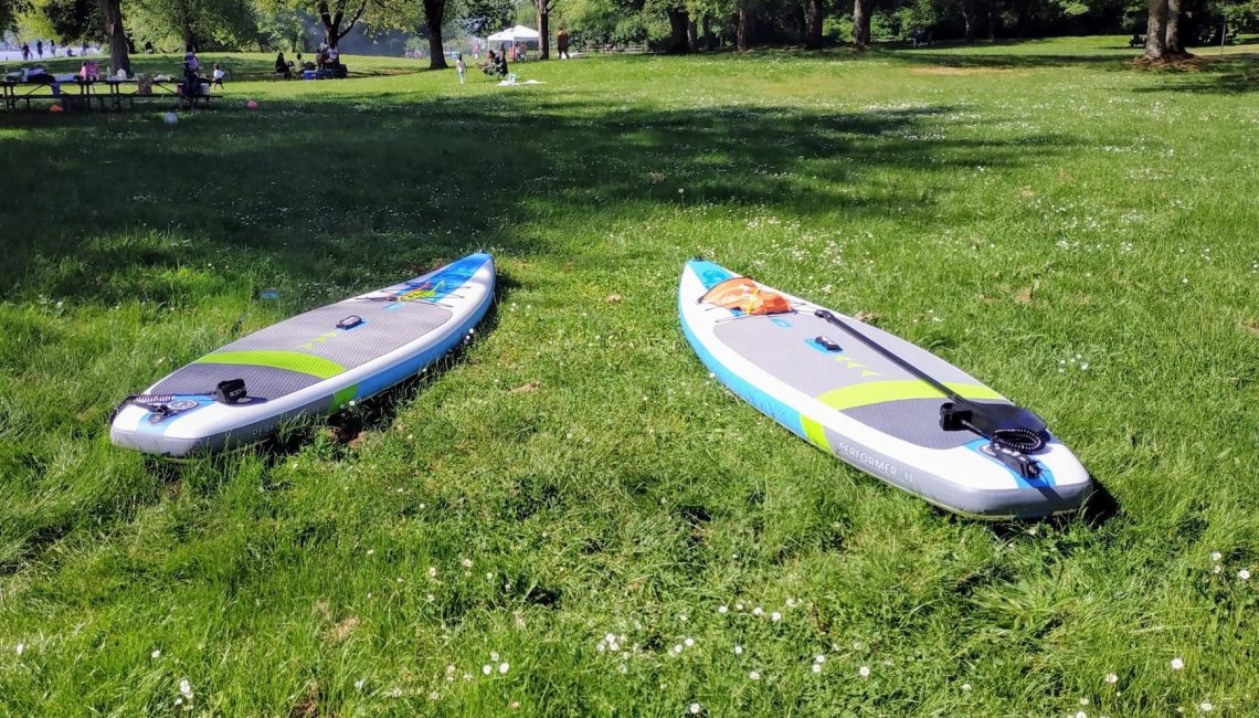 Two SUPs at Lake Sammamish Park on the grass